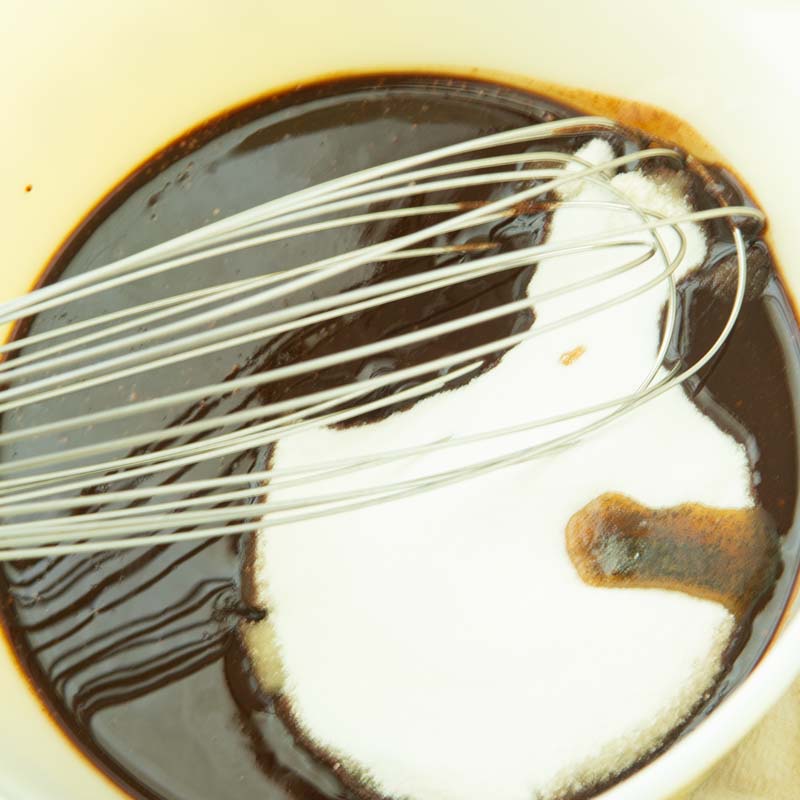 whisking sugar and vanilla into chocolate