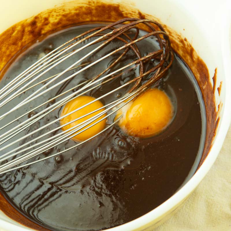 whisking eggs into chocolate