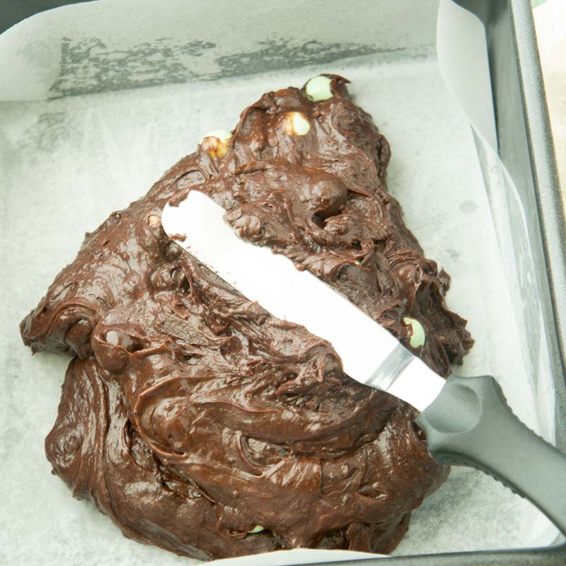 spreading mint brownie batter in pan