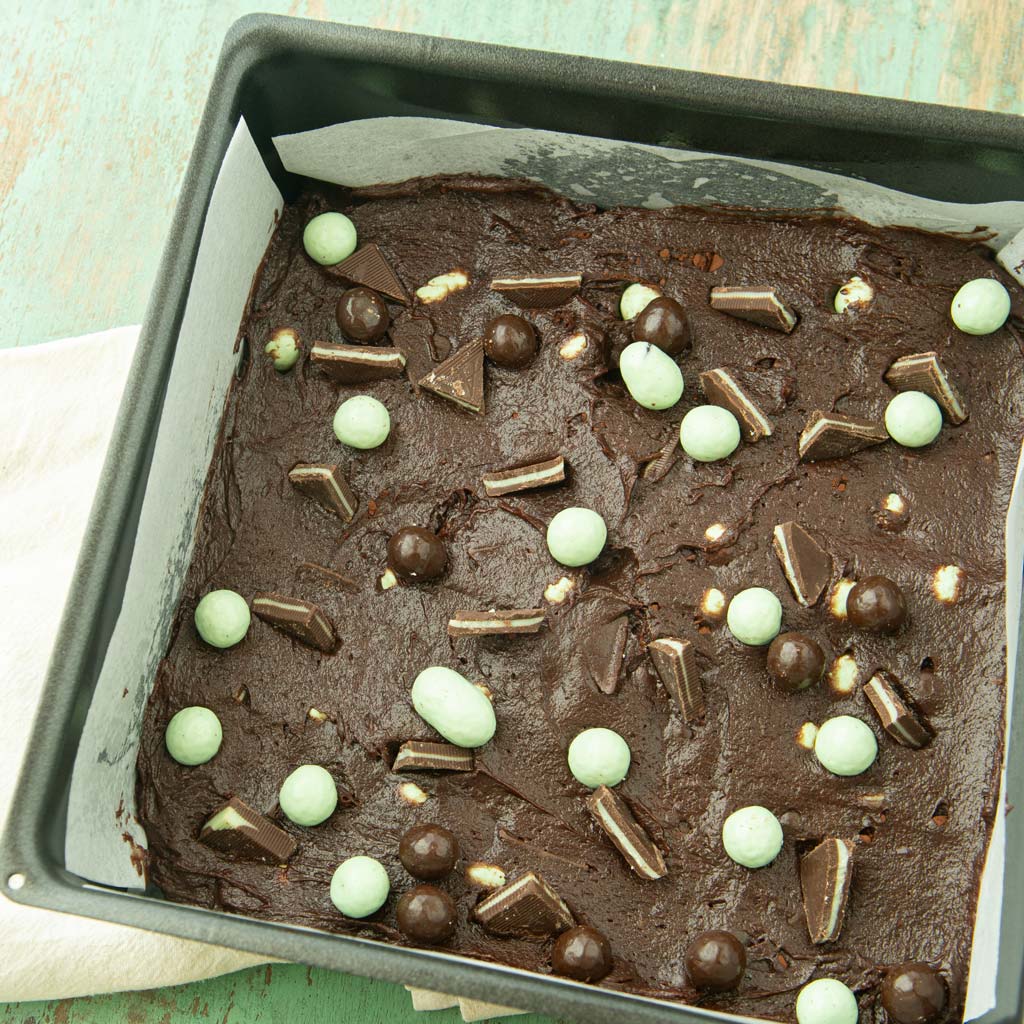 brownie batter topped with Andes mints and mint chocolate cookie bits