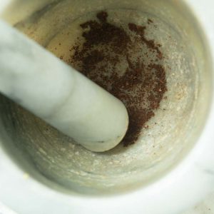 grinding cloves in mortar and pestle
