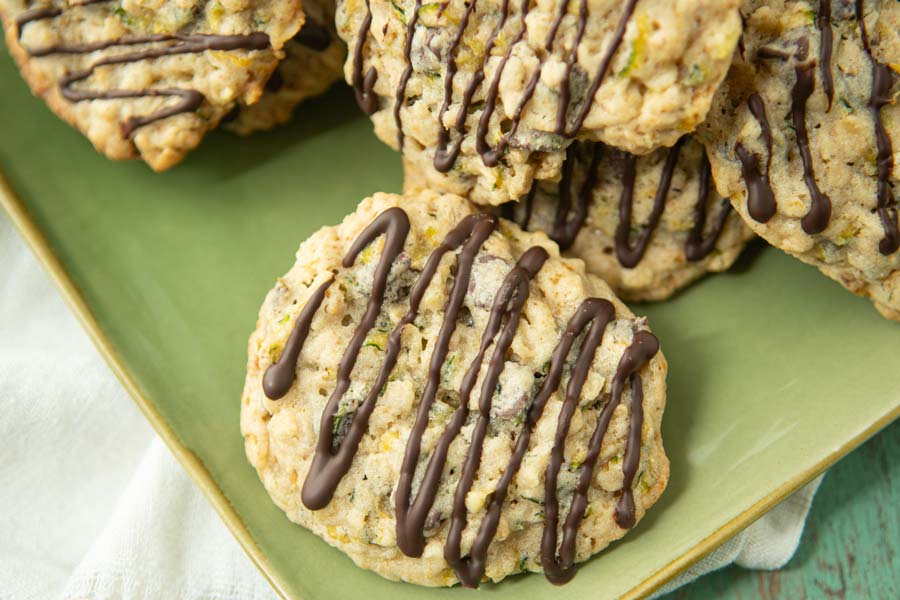 closeup of zucchini cookies drizzled with chocolate