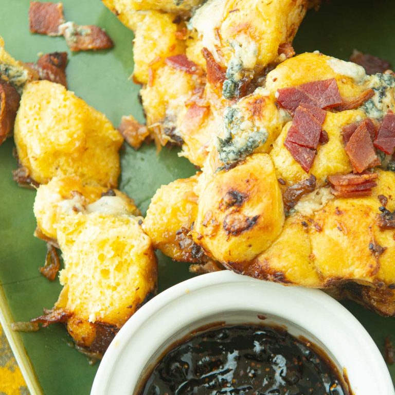 pieces of bacon monkey bread on plate with fig jam