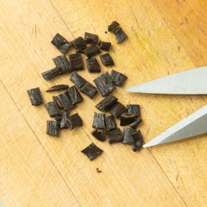snipping vanilla beans into pieces
