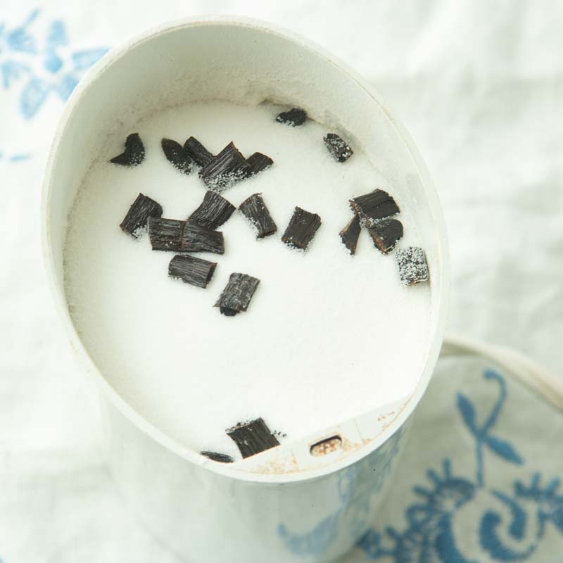 sugar and vanilla bean pieces in coffee grinder