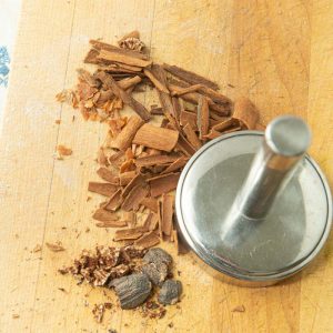 crushing cinnamon sticks and nutmeg