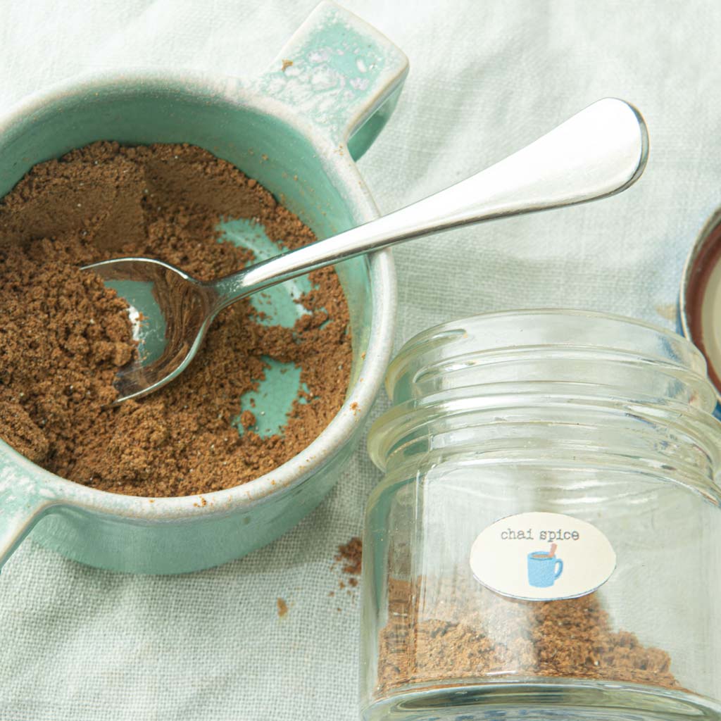 chai spice in bowl with spoon and jar