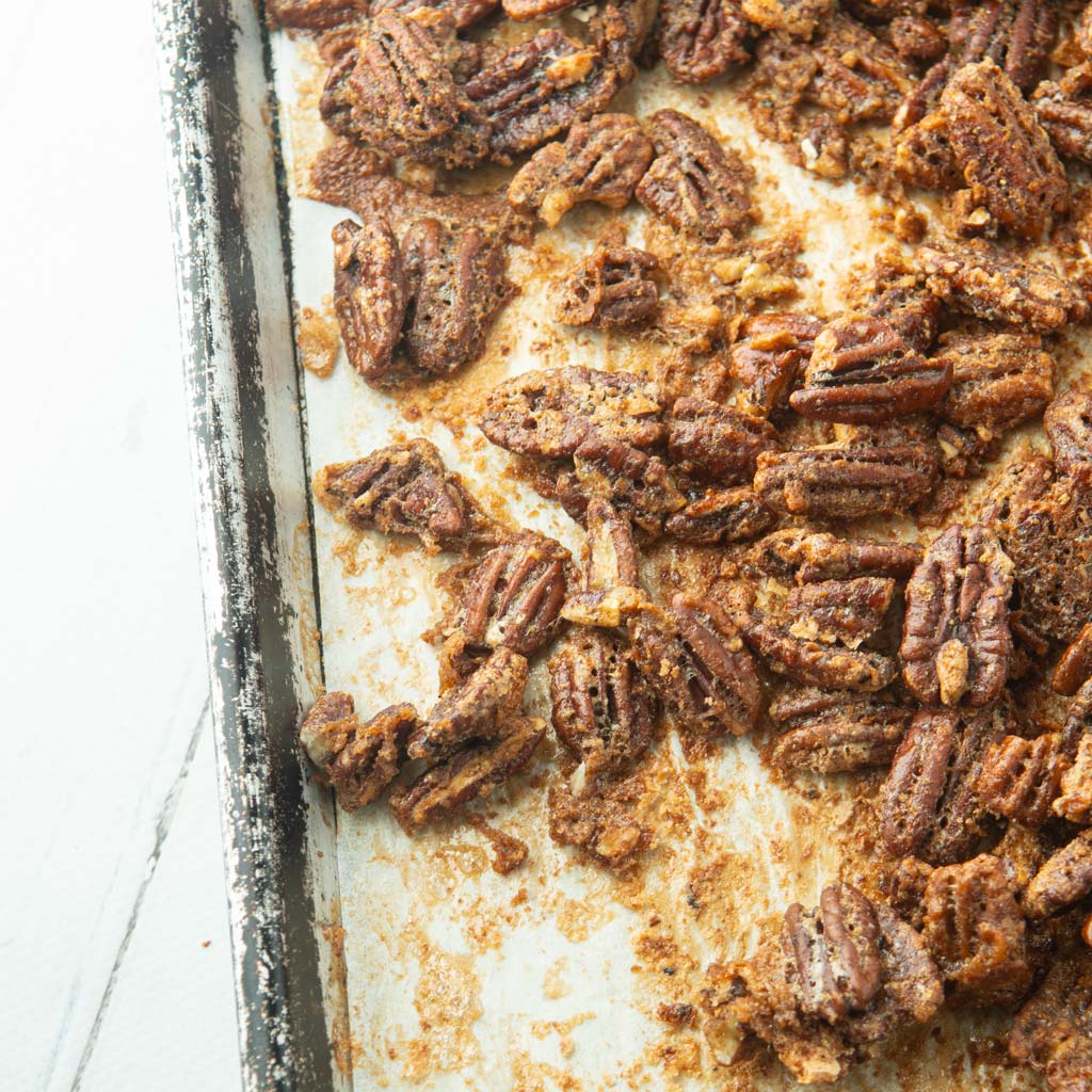 candied maple pecans on a sheet tray