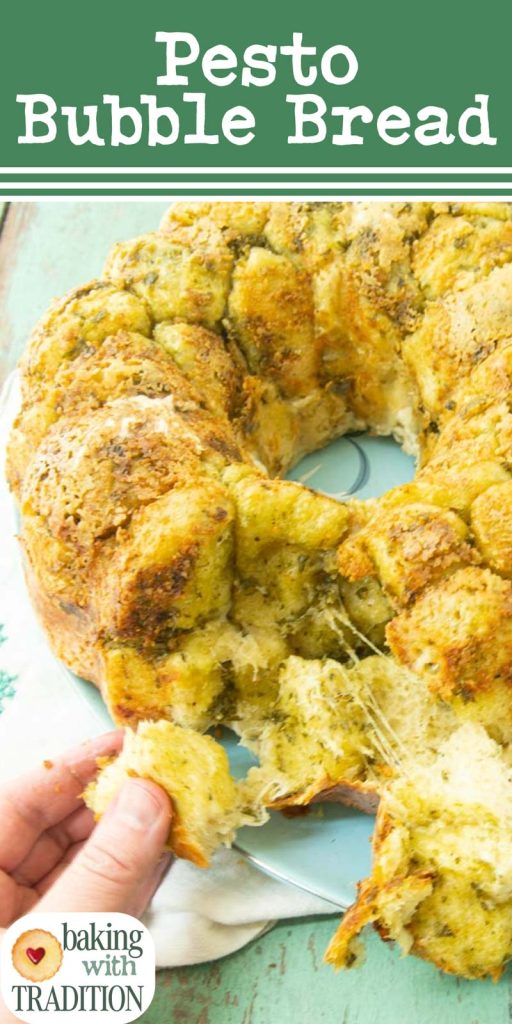 pulling off a piece of pesto monkey bread on plate with text overlay