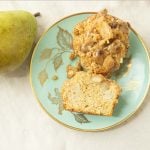 cross section of pear streusel muffin on plate with pear