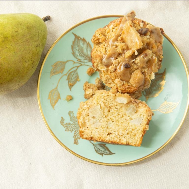 cross section of pear streusel muffin on plate with pear