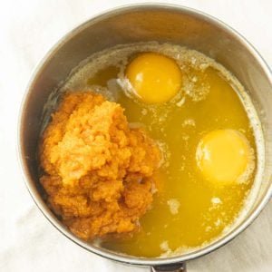 mixing pumpkin, butter, and eggs