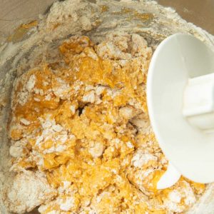 mixing rough dough for pumpkin cinnamon rolls