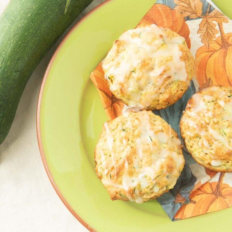 lemon zucchini muffins on plate with zucchini