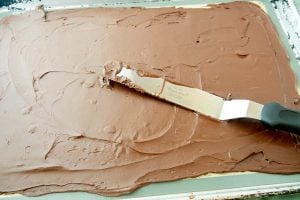 spreading chocolate on silicone mat with offset spatula