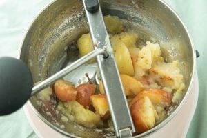 food mill loaded with cooked apples
