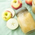 jar of homemade applesauce and apple pieces