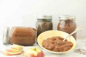 jars of apple butter and dish of apple butter with apple pieces