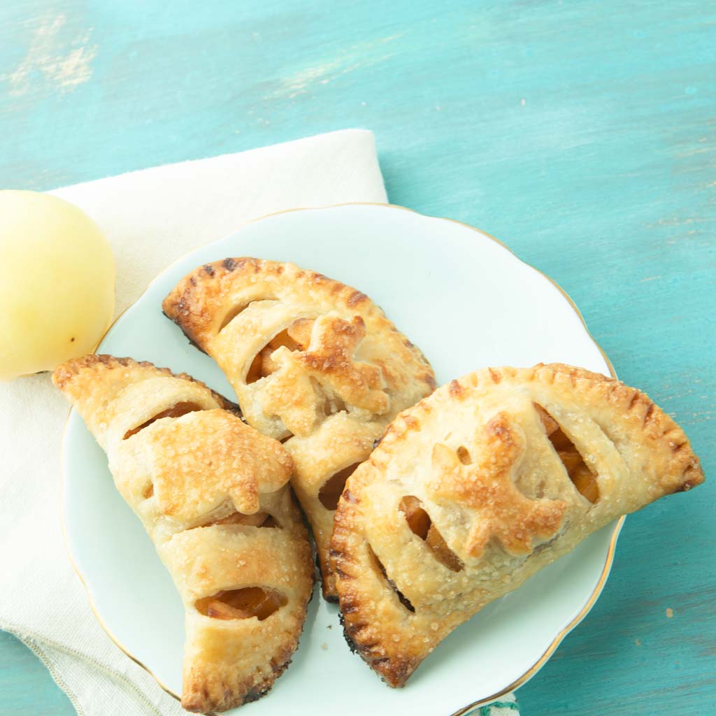 apple hand pies on plate with apple