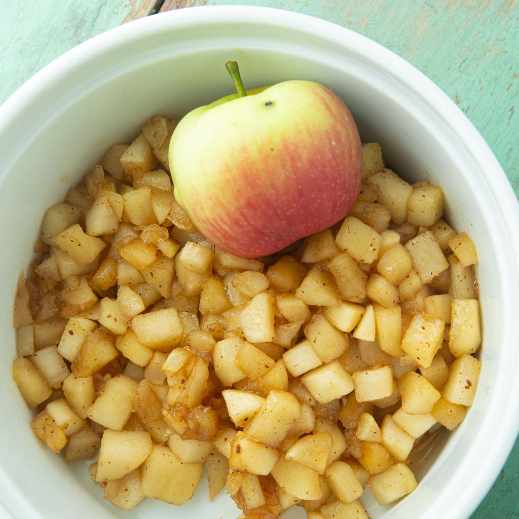 homemade apple pie filling in dish with apple