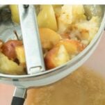apples in food mill straining out applesauce, text overlay