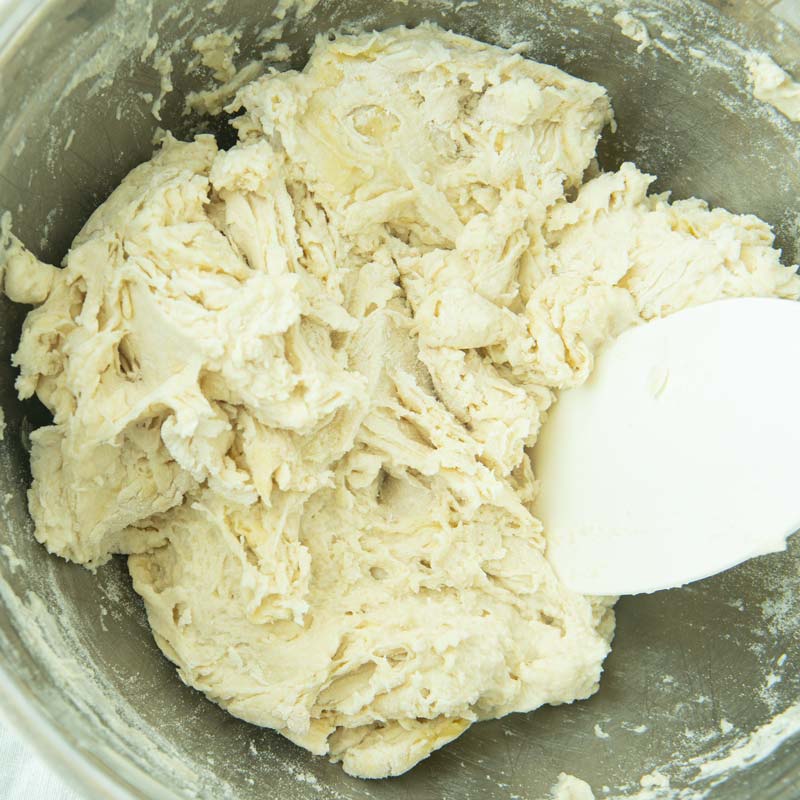 stirring pizza dough ingredients together