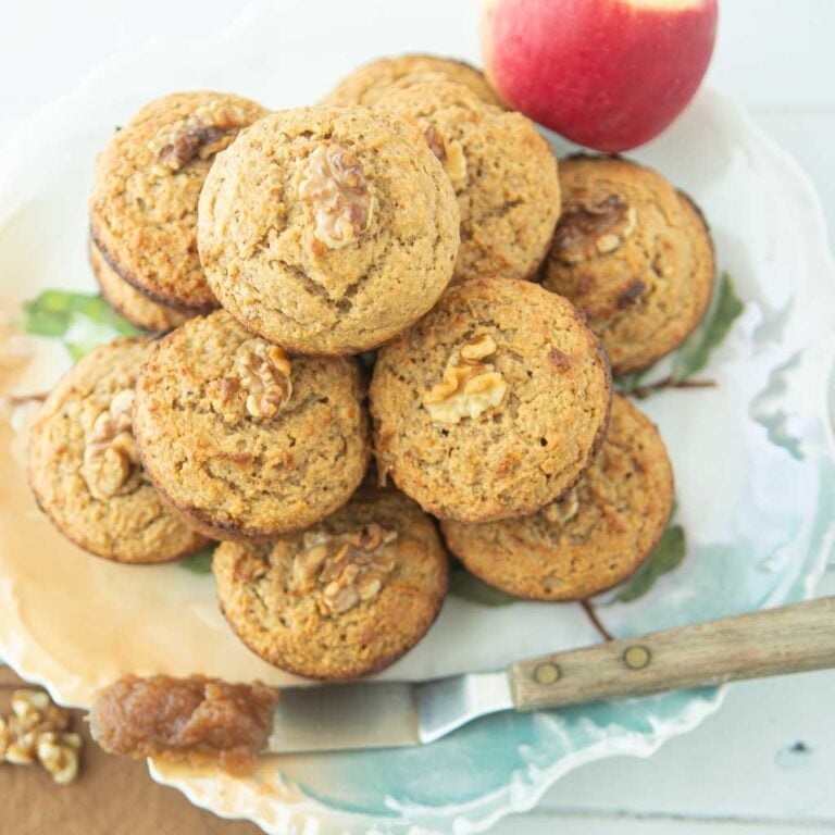 apple butter muffins on plate with apple butter and walnuts and apple