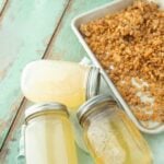jars of rendered lard and crispy cracklings on sheet tray