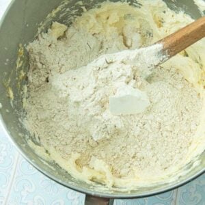 adding flour to apple cake batter