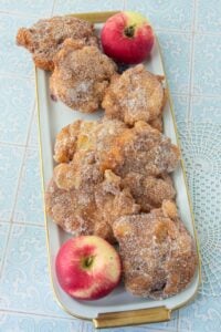 apple fritters on plate with apples