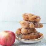 apple fritters stacked on plate
