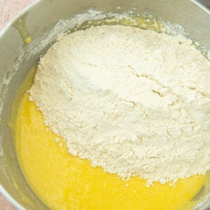 adding flour to batter