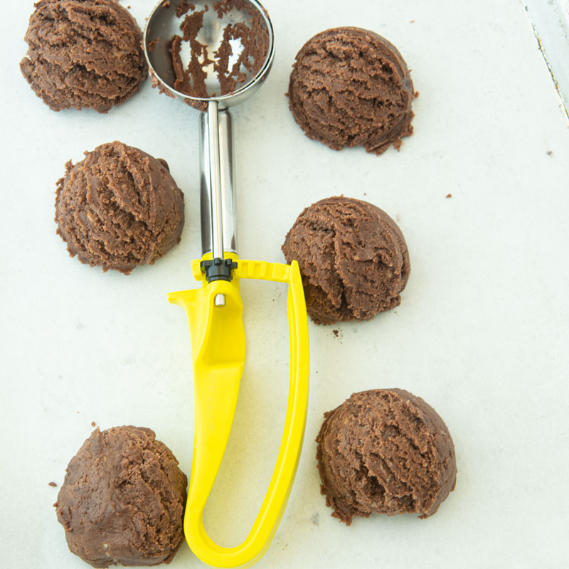 chocolate sugar cookies dough balls with cookie scoop