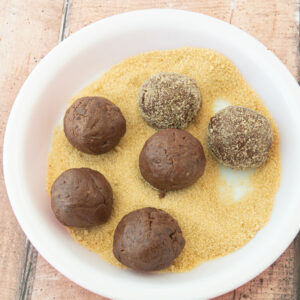 rolling chocolate dough in raw sugar
