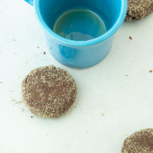 flattening chocolate sugar cookies with glass