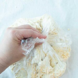 pressing cream cheese pastry dough together in plastic