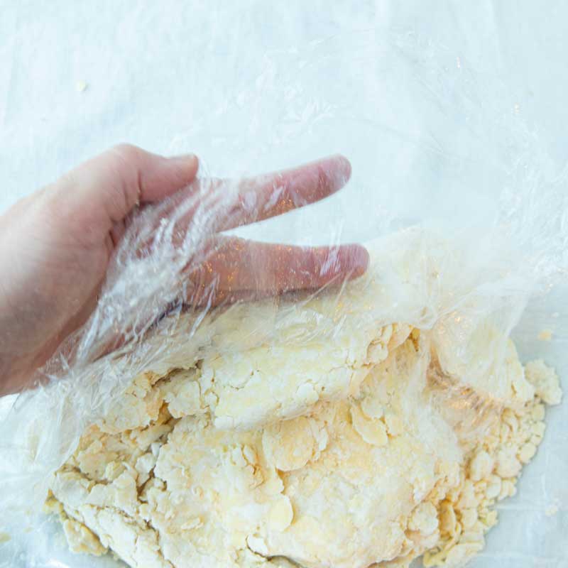 folding cream cheese pastry together in plastic