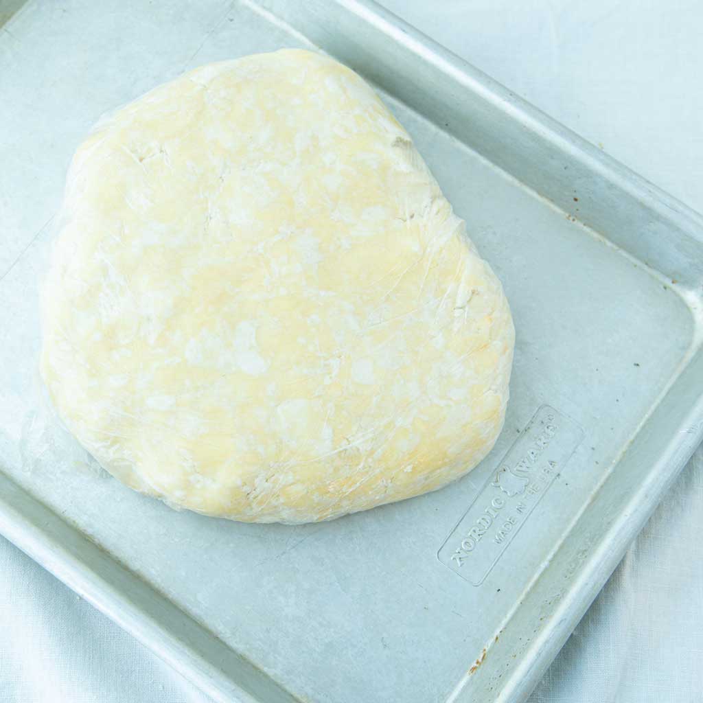 cream cheese pastry disk on sheet tray