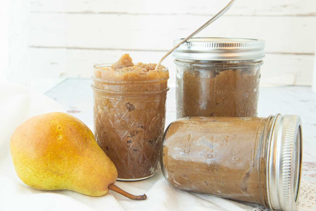 pear butter in jars with whole pear