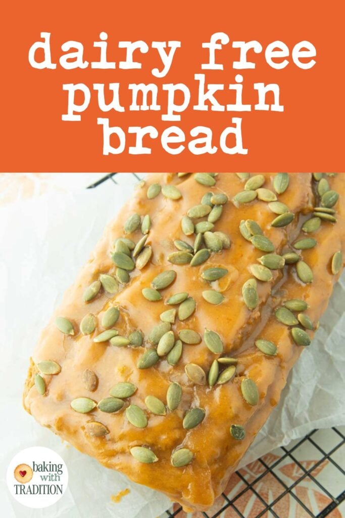 loaf of pumpkin bread iced with pumpkin glaze and covered with toasted pumpkin seeds, text overlay
