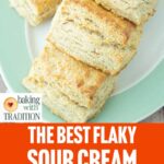 closeup of sour cream biscuits on plate with text overlay