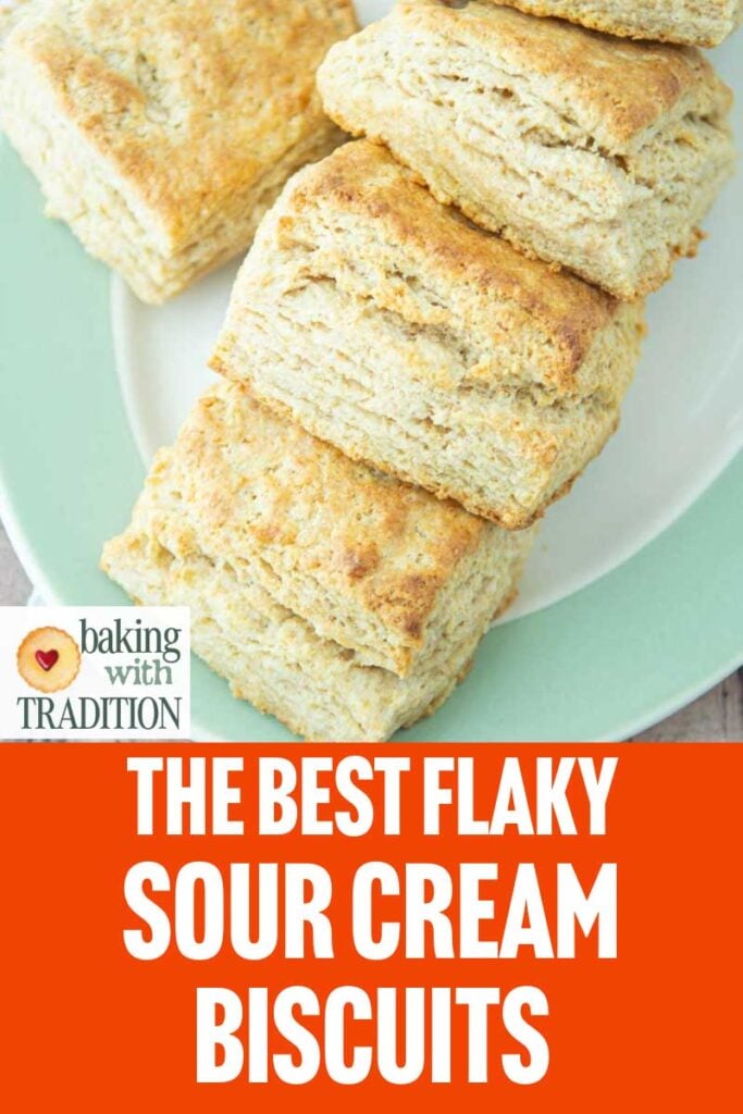 closeup of sour cream biscuits on plate with text overlay