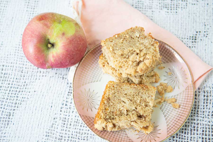apple with pieces of applesauce bread on plate