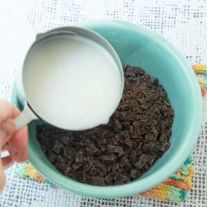 pouring coconut milk over chocolate