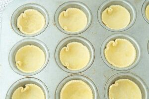 unbaked quiches in muffin pan