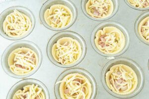 unbaked quiches in muffin pan