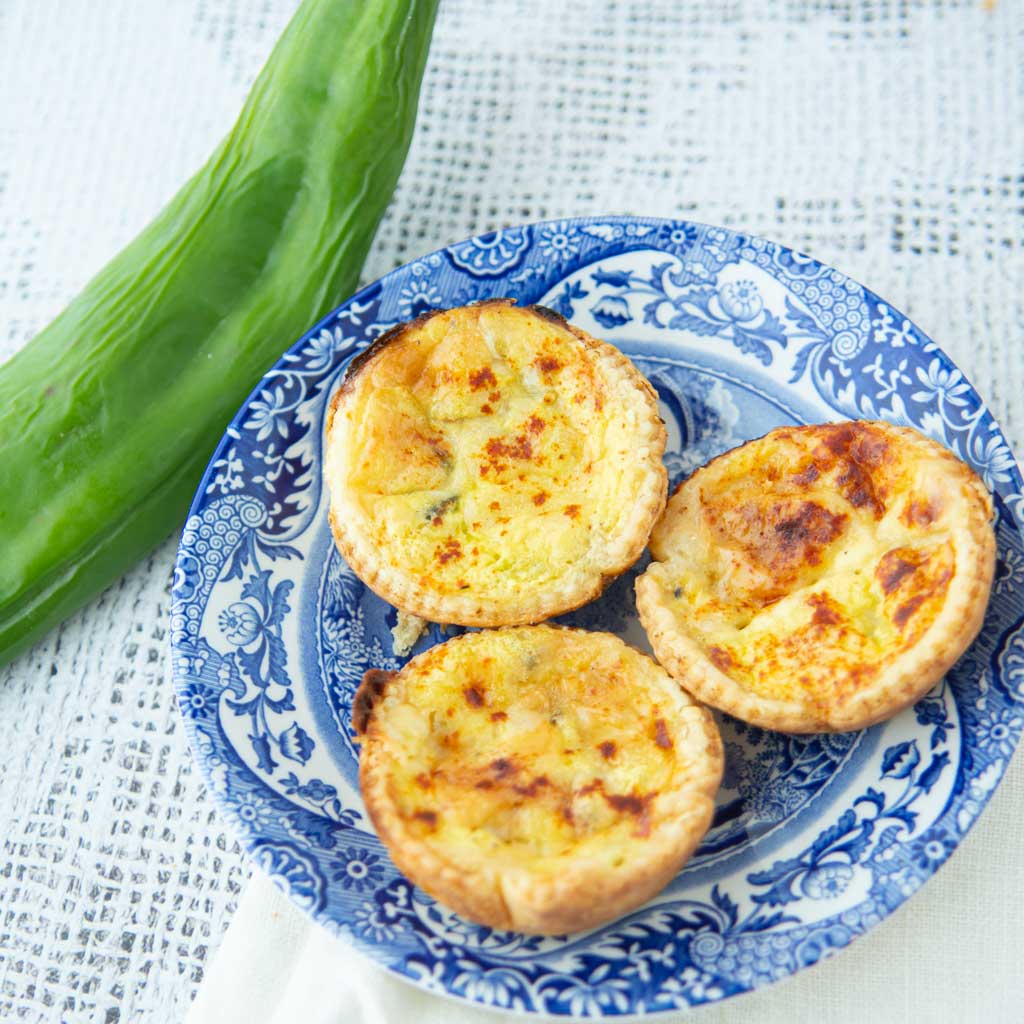 whole green chile and green chile mini quiches on plate