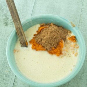 whisking milk into pumpkin puree and spices