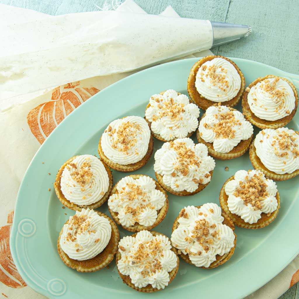 mini pumpkin pies with whipped cream frosting