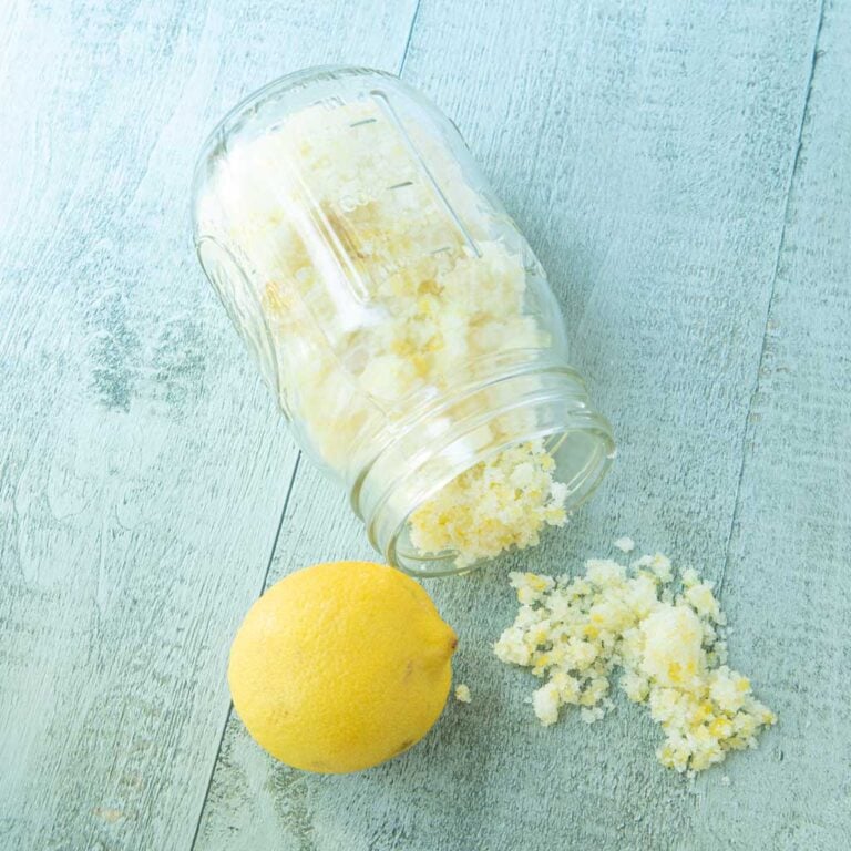 lemon sugar spilling out of jar and whole lemon